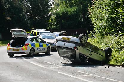 Car flips on roof outside war memorial