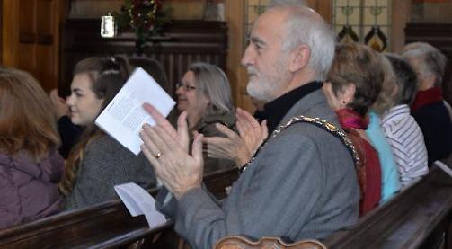Harpist and handbell ringers at charity concert