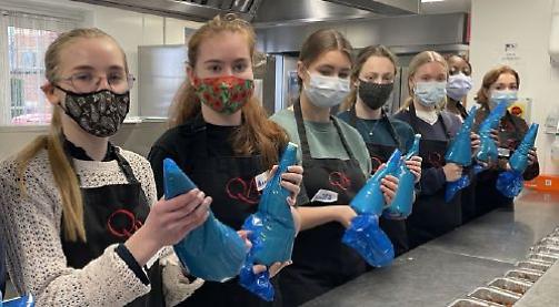 Sixth-form girls help provide meals for people in need
