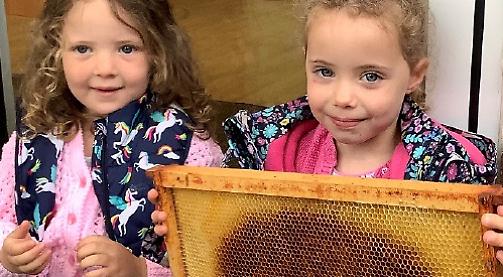 Nursery children buzzing at beekeeper visit