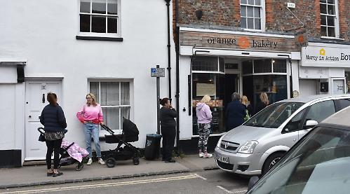 Customers queue outside bakery for book signing