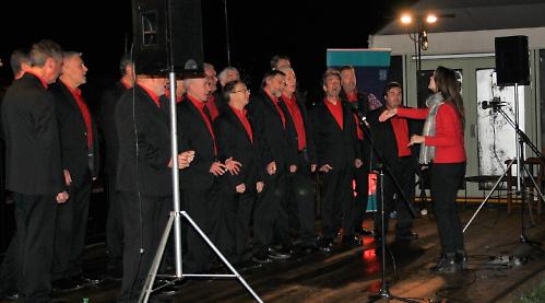 Living Advent Calendar Day 21: A gleaming river backdrop for a capella group at Leander
