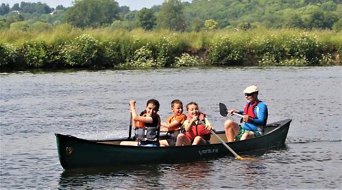 Families enjoy themselves on river before thunderstorm