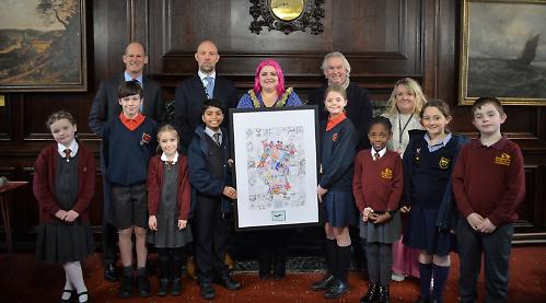 Children present their colourful portrait of King to town