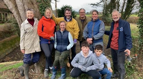 Villagers clear disused water tank of overgrown scrub