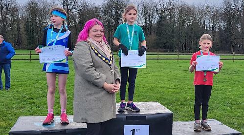 Children run up hill on chilly, soggy Saturday morning... for fun!