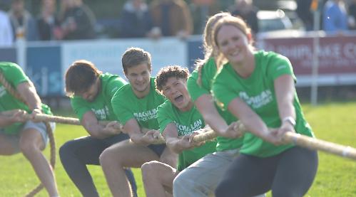 Athletes do battle in tug of war for cancer charity