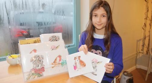 Budding artist sells festive nature cards at village shop