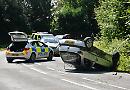 Car flips on roof outside war memorial