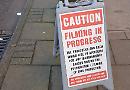 Silence please: passers-by witness TV crime drama being filmed at shop