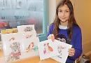 Budding artist sells festive nature cards at village shop