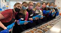 Sixth-form girls help provide meals for people in need