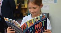 Former parents help school expand its library books