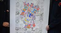Children present their colourful portrait of King to town