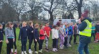 Children run up hill on chilly, soggy Saturday morning... for fun!