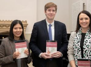 Teacher passing on love of poetry to pupils with book