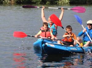 Families enjoy themselves on river before thunderstorm