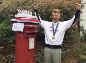 Knitted topper that captures cox’s gold medal celebration