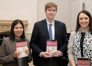 Teacher passing on love of poetry to pupils with book