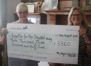 Ex-mayor presents £6,720 to two charities