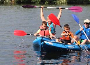 Families enjoy themselves on river before thunderstorm