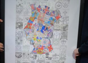 Children present their colourful portrait of King to town