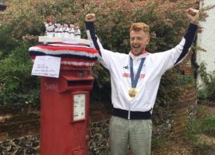 Knitted topper that captures cox’s gold medal celebration