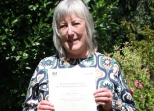 Woman achieves highest award for playing piano