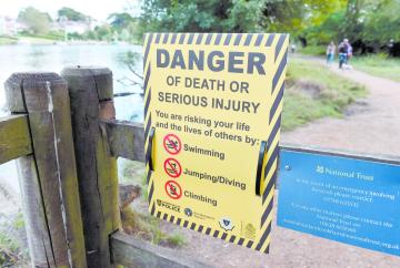 TAPLOW 134647-1. Flowers left at the Jubilee River in memory of Ruben Iwe , who died aged 16 in the river in June 2022.
