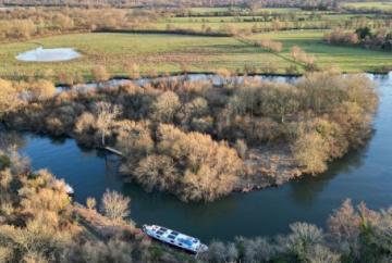 Heavily wooded island in Thames sold at auction for almost £100,000