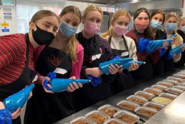 Sixth-form girls help provide meals for people in need