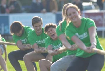 Athletes do battle in tug of war for cancer charity