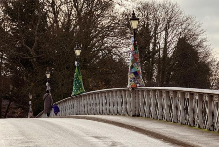 Knitting group adorn bridge with ‘trees’ in aid of church