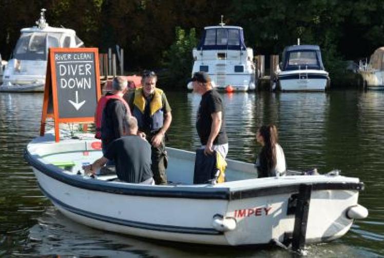 Evidence of celebration as diver begins riverbed rubbish clean-up