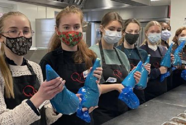 Sixth-form girls help provide meals for people in need