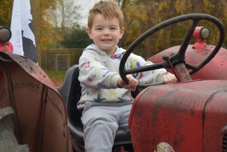 Tractors take people to farm service