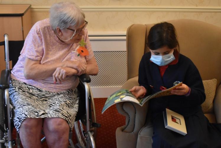 Children visit care home and read aloud to residents