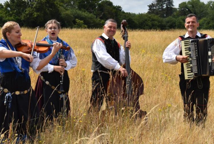 Friends make song and dance in field