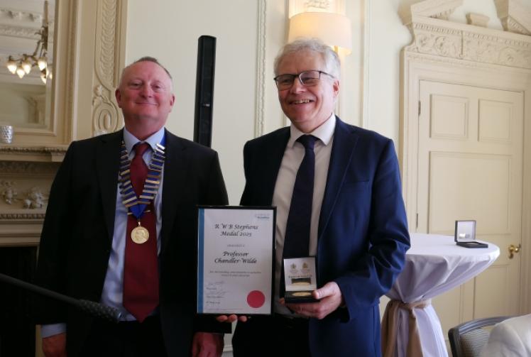 Maths professor presented with award by his former student