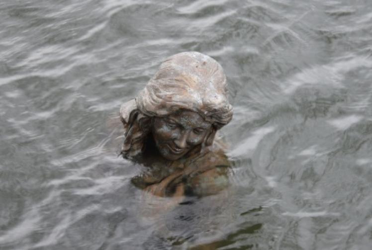 Mermaid statue pushed in to river